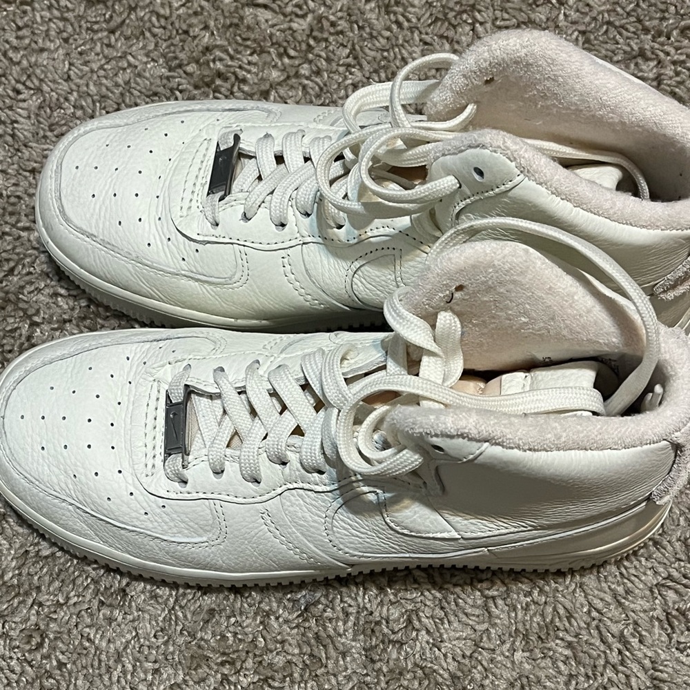 white and pink high top nike air forces.